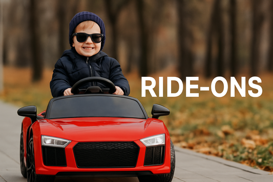 A young child in sunglasses smiling while riding a red electric ride-on car in a park during fall. Text overlay reads 'RIDE-ONS'.