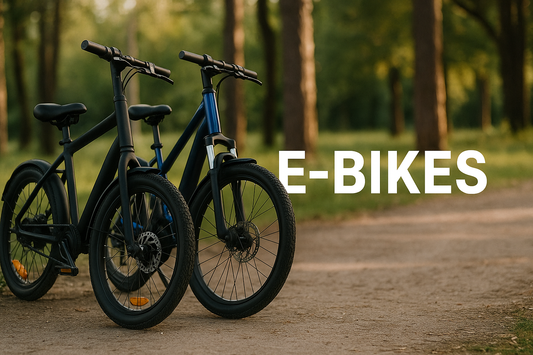Two electric bikes on a dirt trail in a wooded area during golden hour. Text overlay reads 'E-BIKES'.